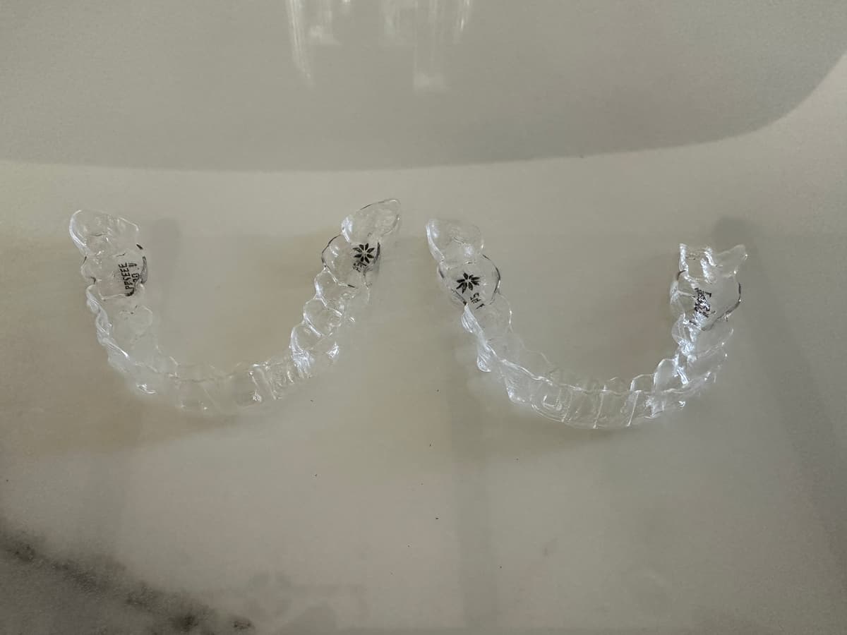 Clear dental retainer trays on countertop