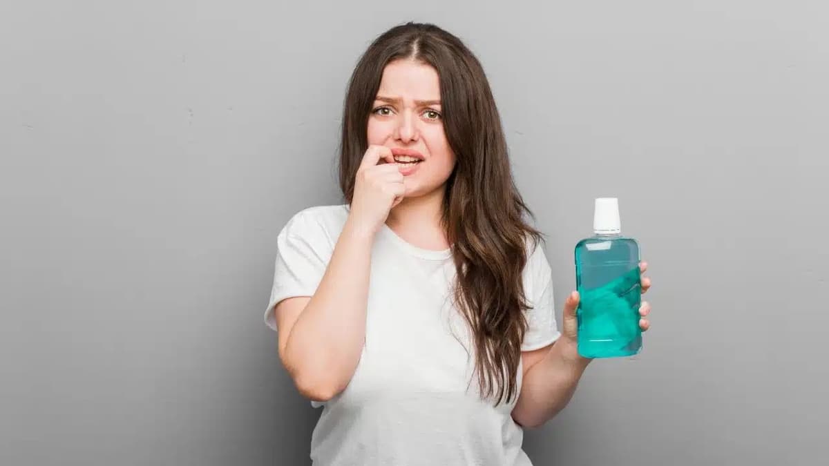 Oral hygiene products including mouthwash and interdental brushes on a countertop