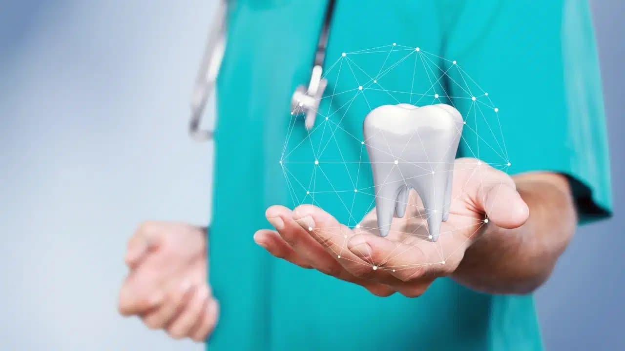 Dental professional holding a 3D tooth model with glowing digital overlay representing modern dental science